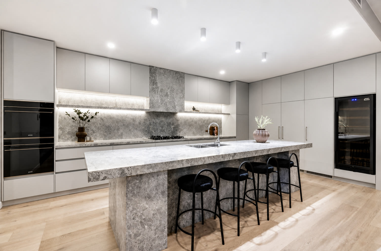 Finished Melbourne kitchen with a stone waterfall island and integrated appliances